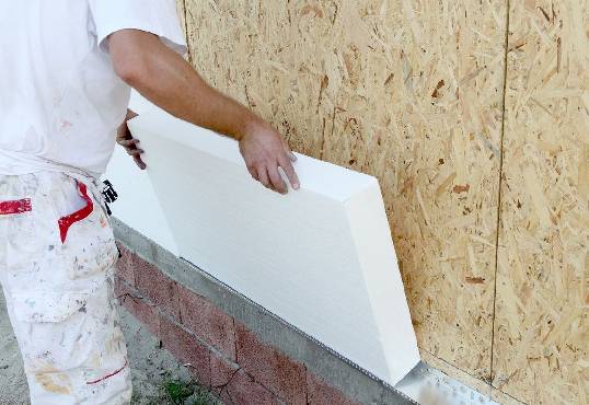 A person holding a piece of white foam.