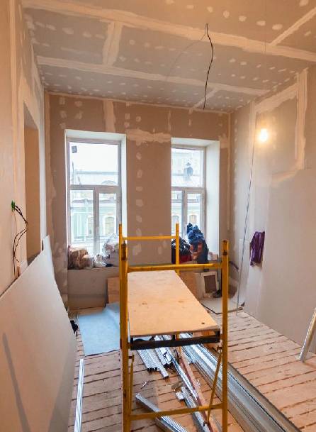 A room being remodeled with the walls and ceiling removed.